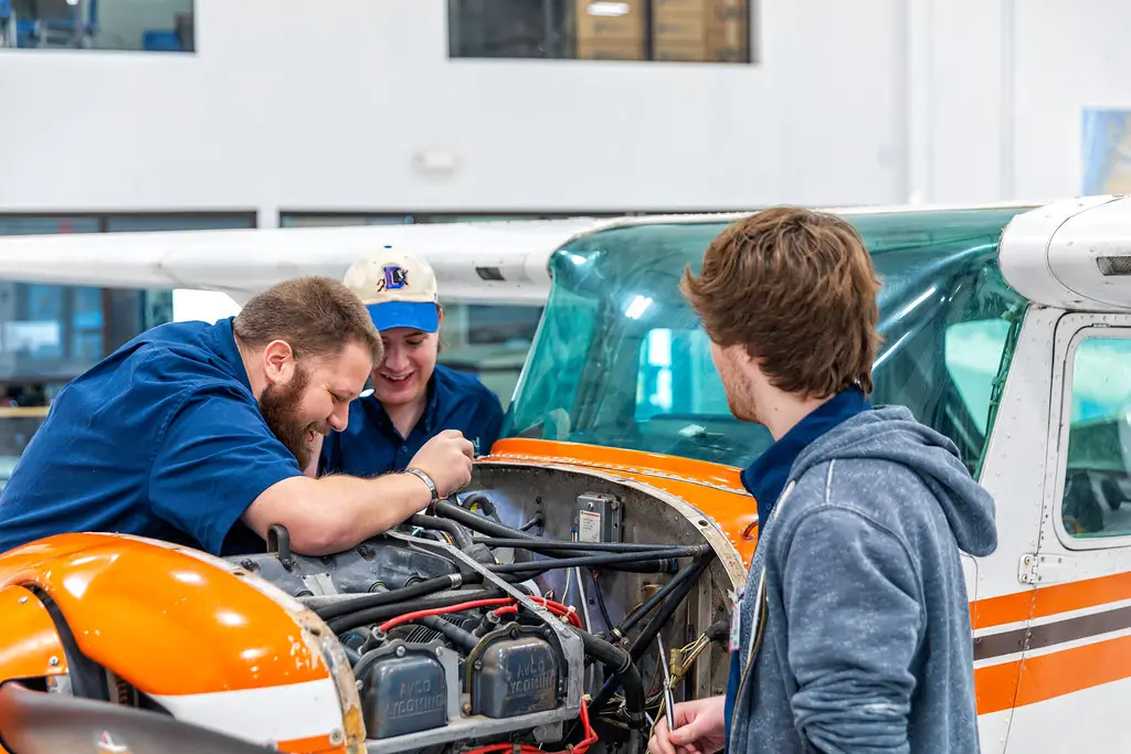Students working on a plane engine