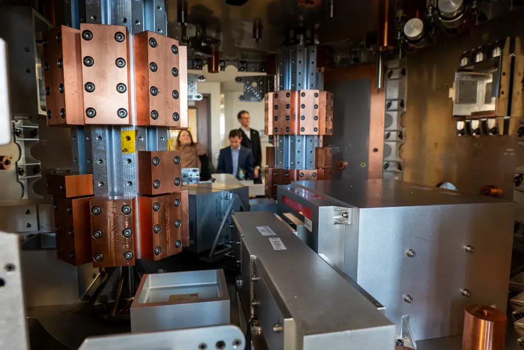 People touring the Spaceflight Labratory, machines surrounding them