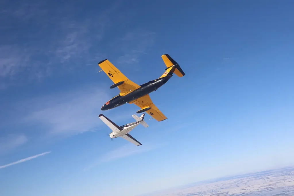 two airplanes flying in a clear blue sky