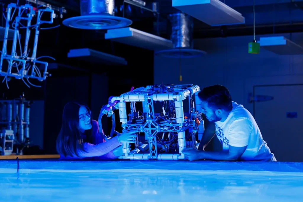 Young man and woman testing a cube structure in a Buoyancy Tank